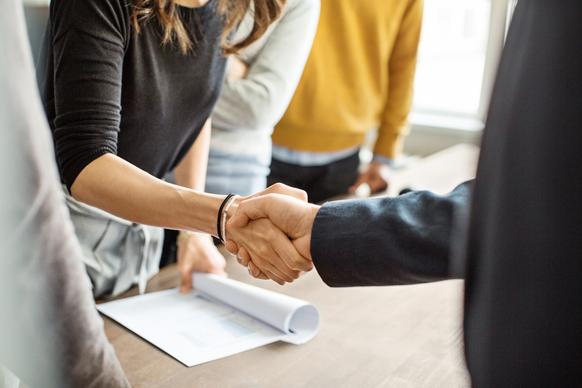 man and a woman shake hands in business meeting